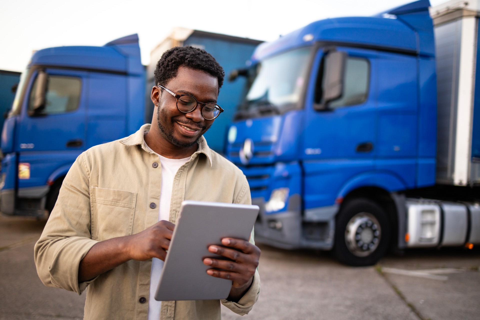 Professional truck driver checking the rout via application on digital tablet.